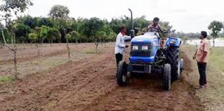 উত্তারাঞ্চলে জমি চাষের ট্রাক্টর